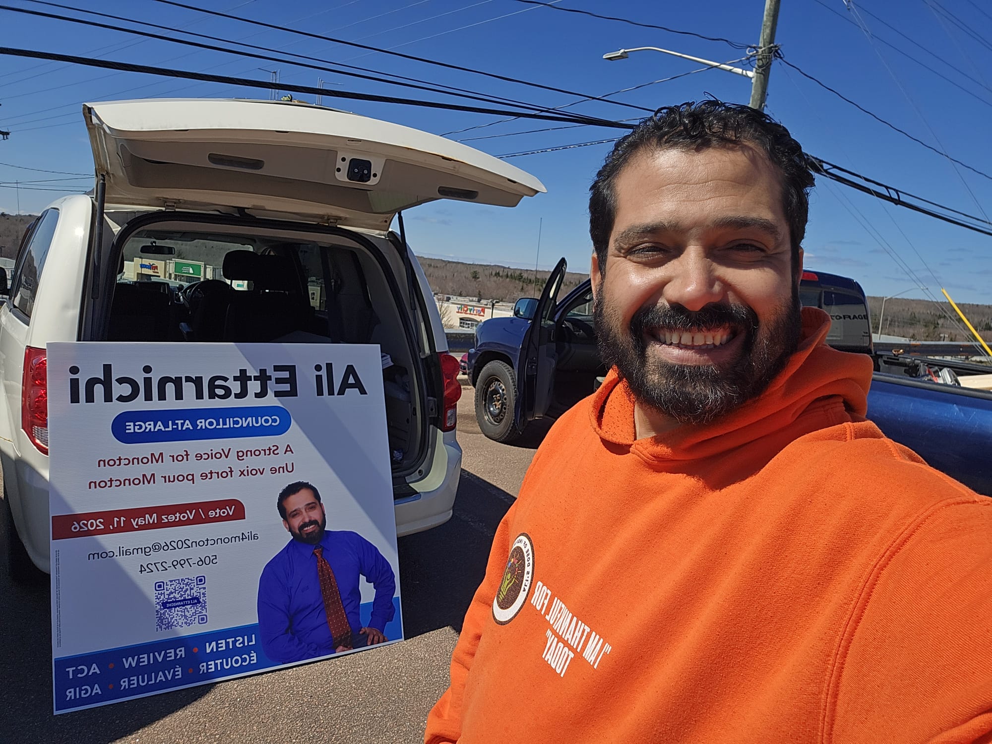 Ali Ettarnichi 2026 campaign volunteers putting up signs in Moncton